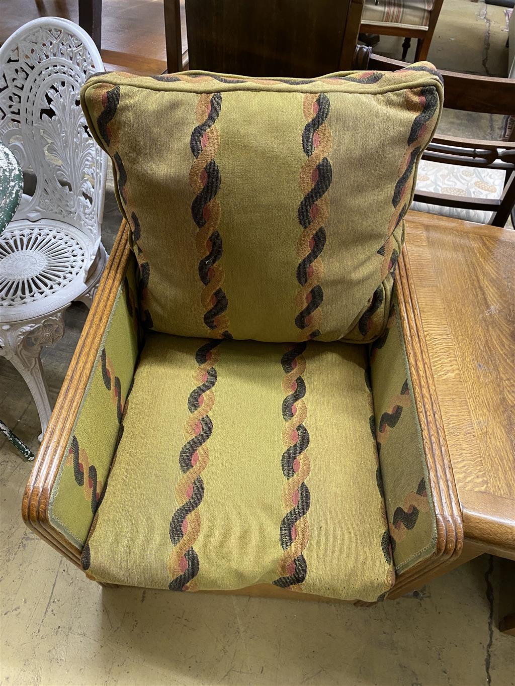 An Art Deco oak three section conversation seat, possibly with its original upholstery, width 170cm, depth 70cm, height 71cm